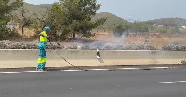 Un barrendero apaga un fuego en un margen de la carretera que une Ibiza con Sant Antoni
